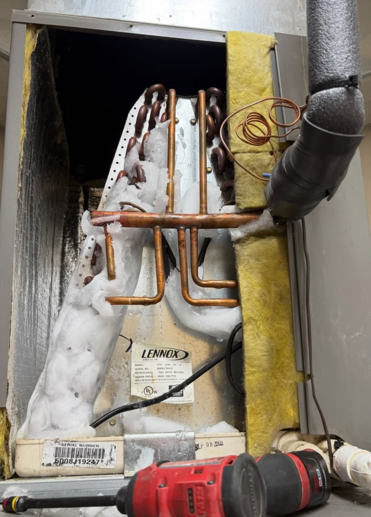 Lennox evaporator coil covered in ice inside an open air handler