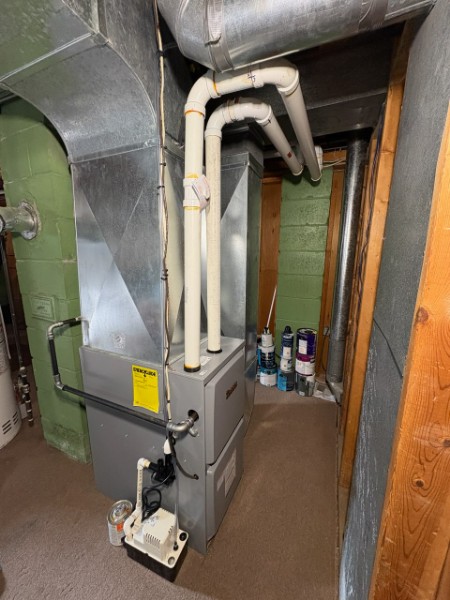 High-efficiency gas furnace with metal ductwork and PVC vent pipes